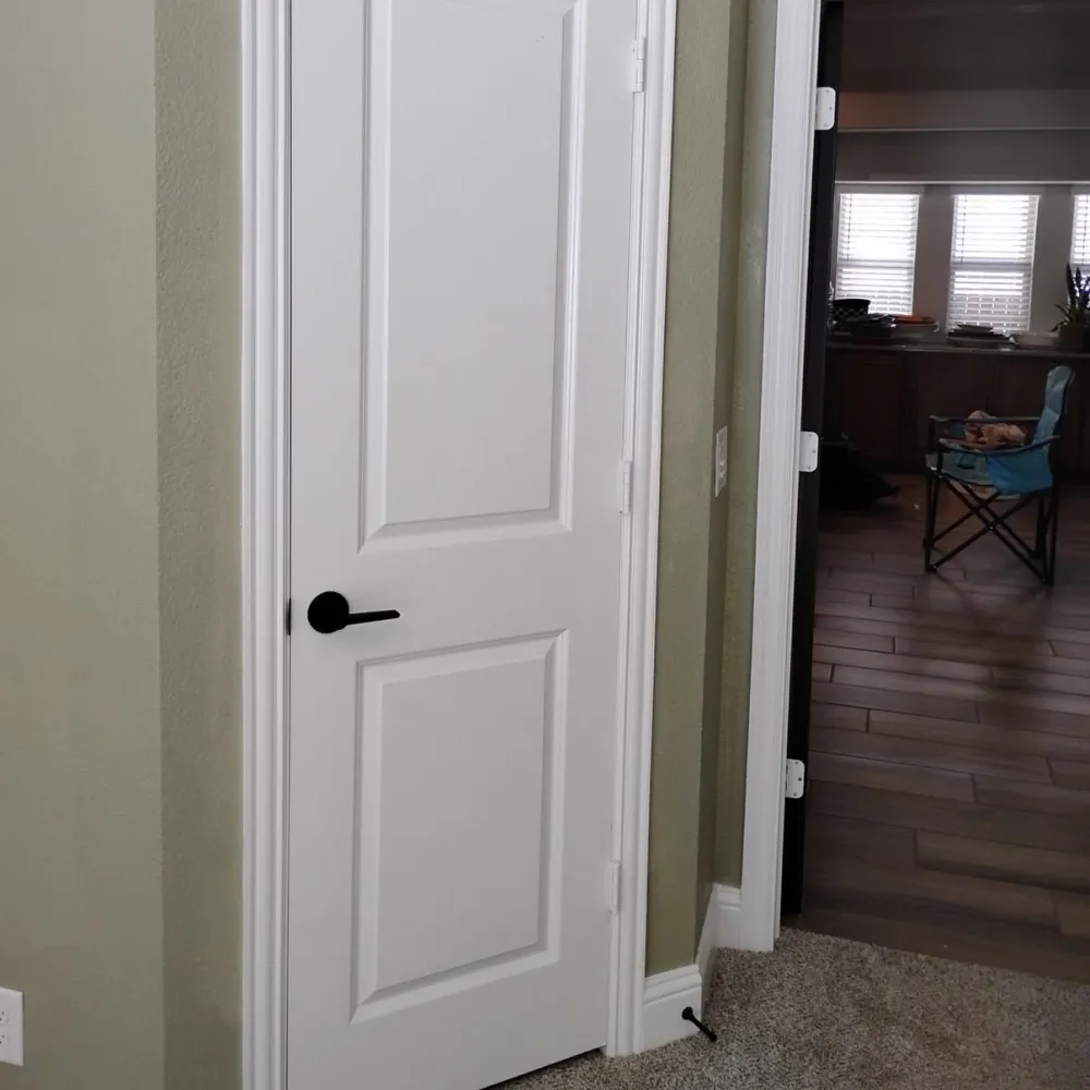 Interior update with white door, dark hardware and flooring transition